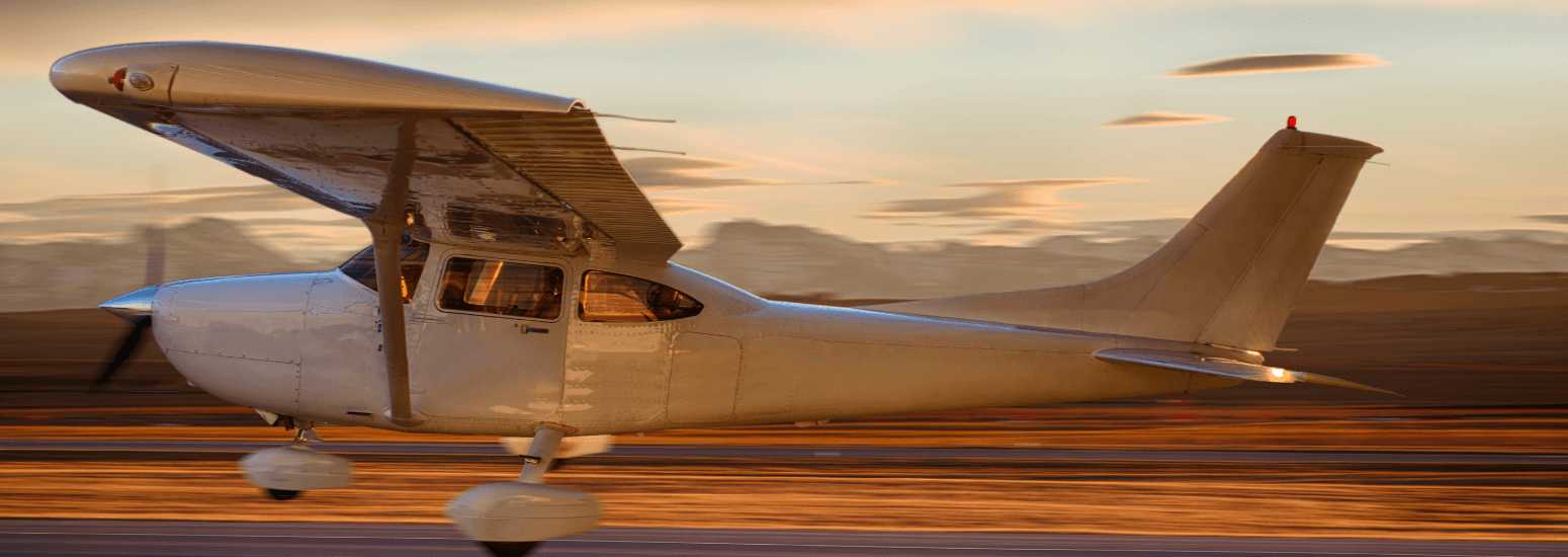Small plane on the runway at sunrise